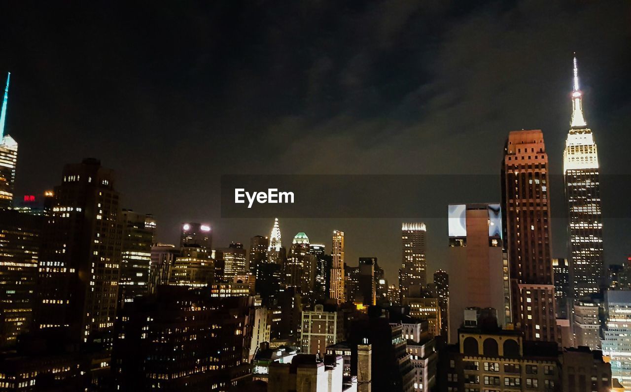 View of skyscrapers lit up at night