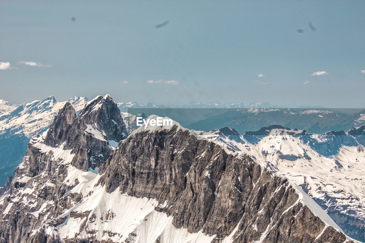 Panoramic view of snowcapped mountains against sky