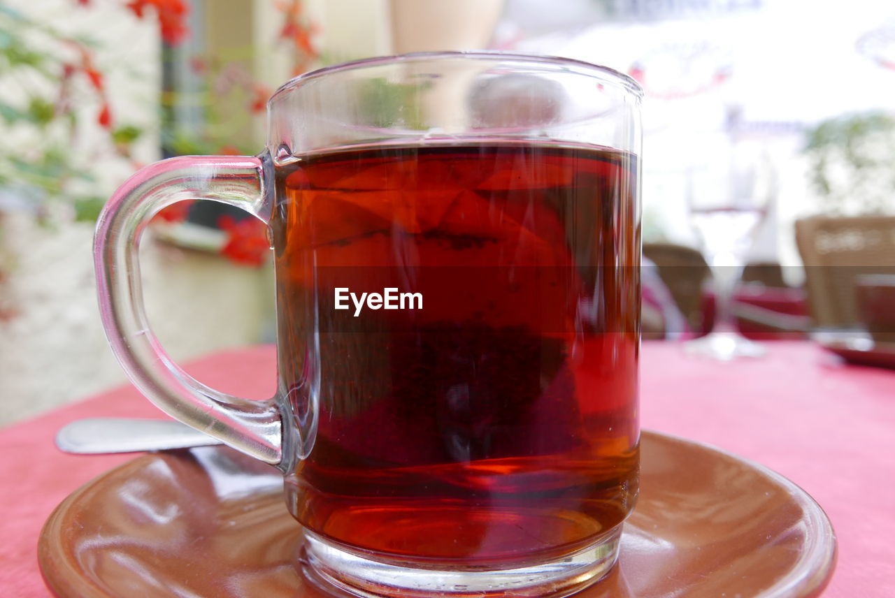 Close-up of cup with teabag on table