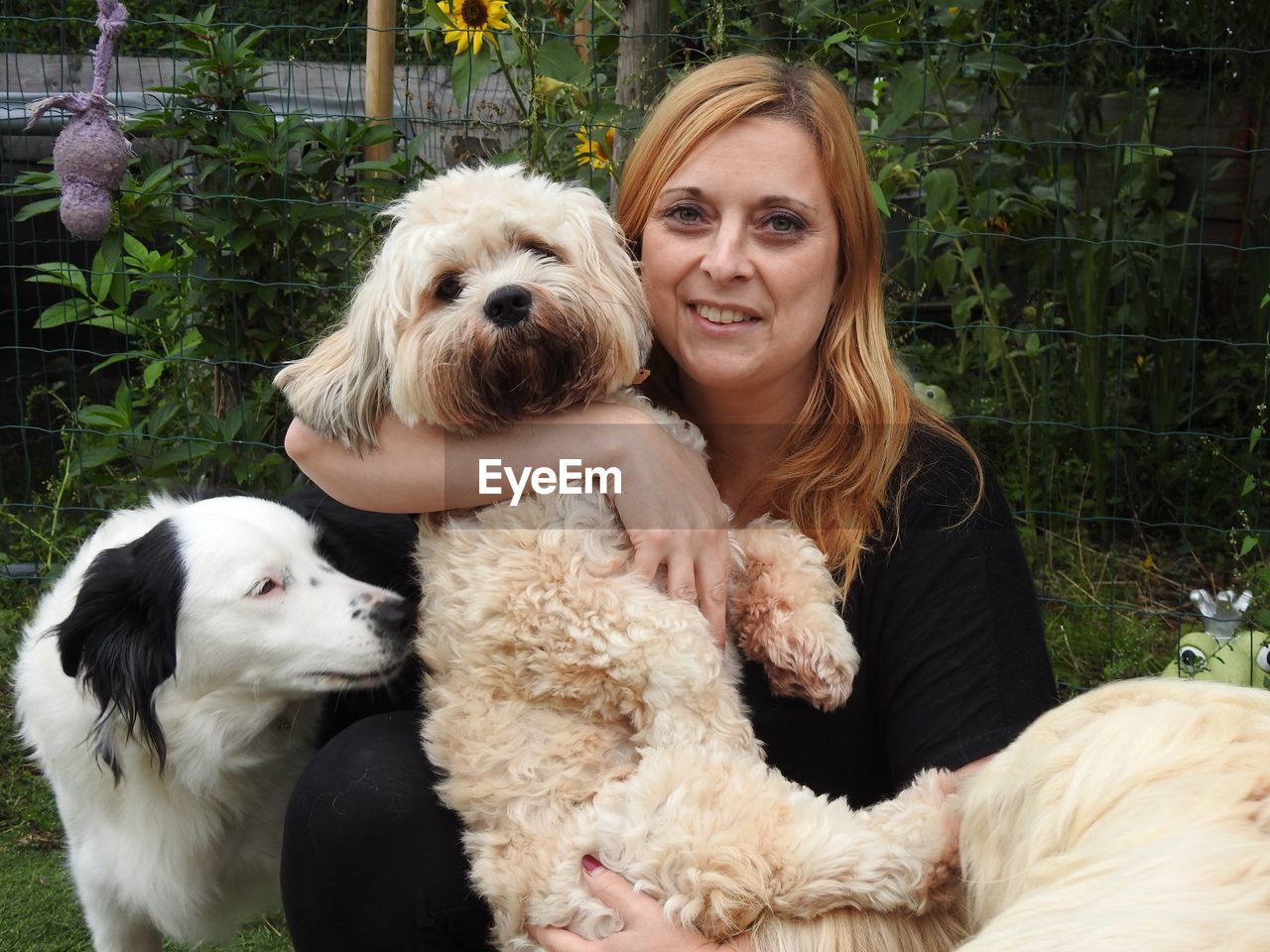 Portrait of smiling mid adult woman with dogs in park