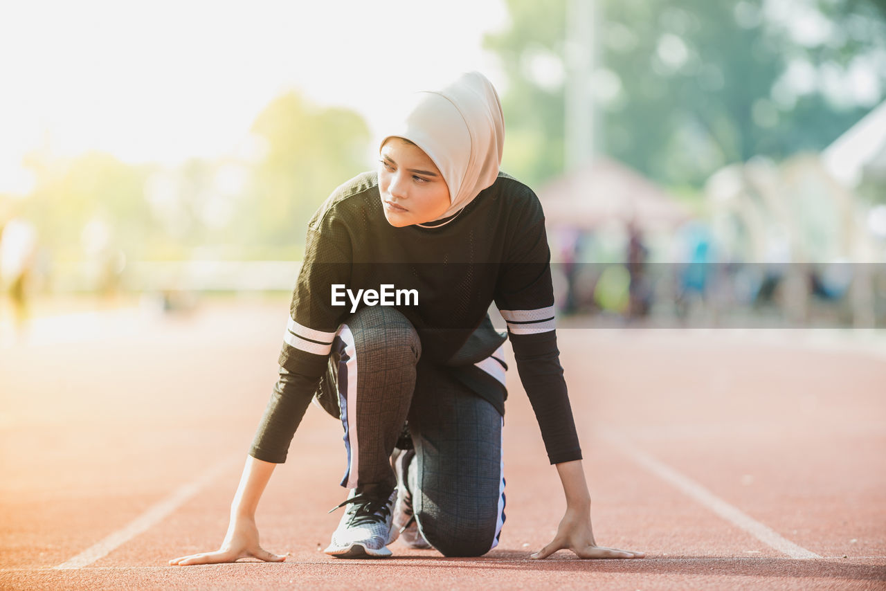 Female athlete exercising on track