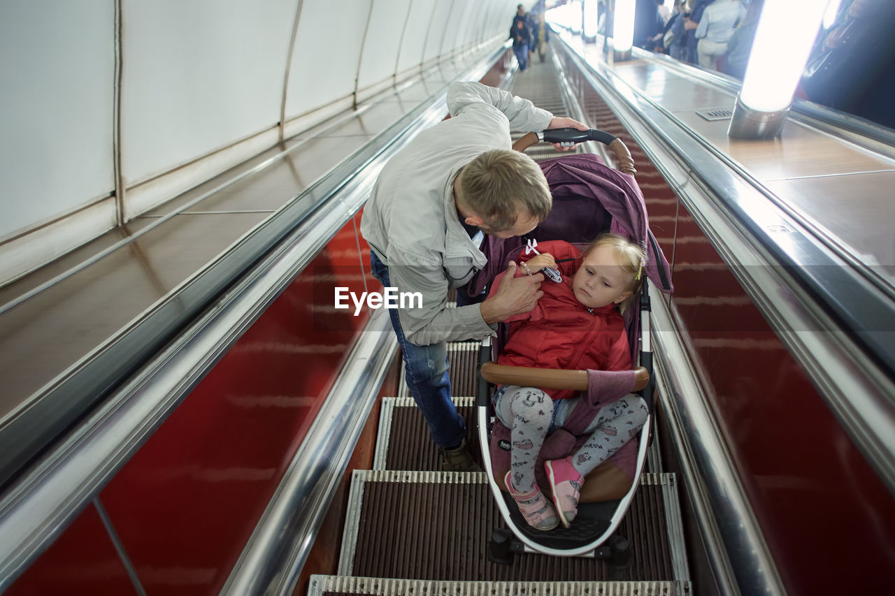 Rear view of people on escalator