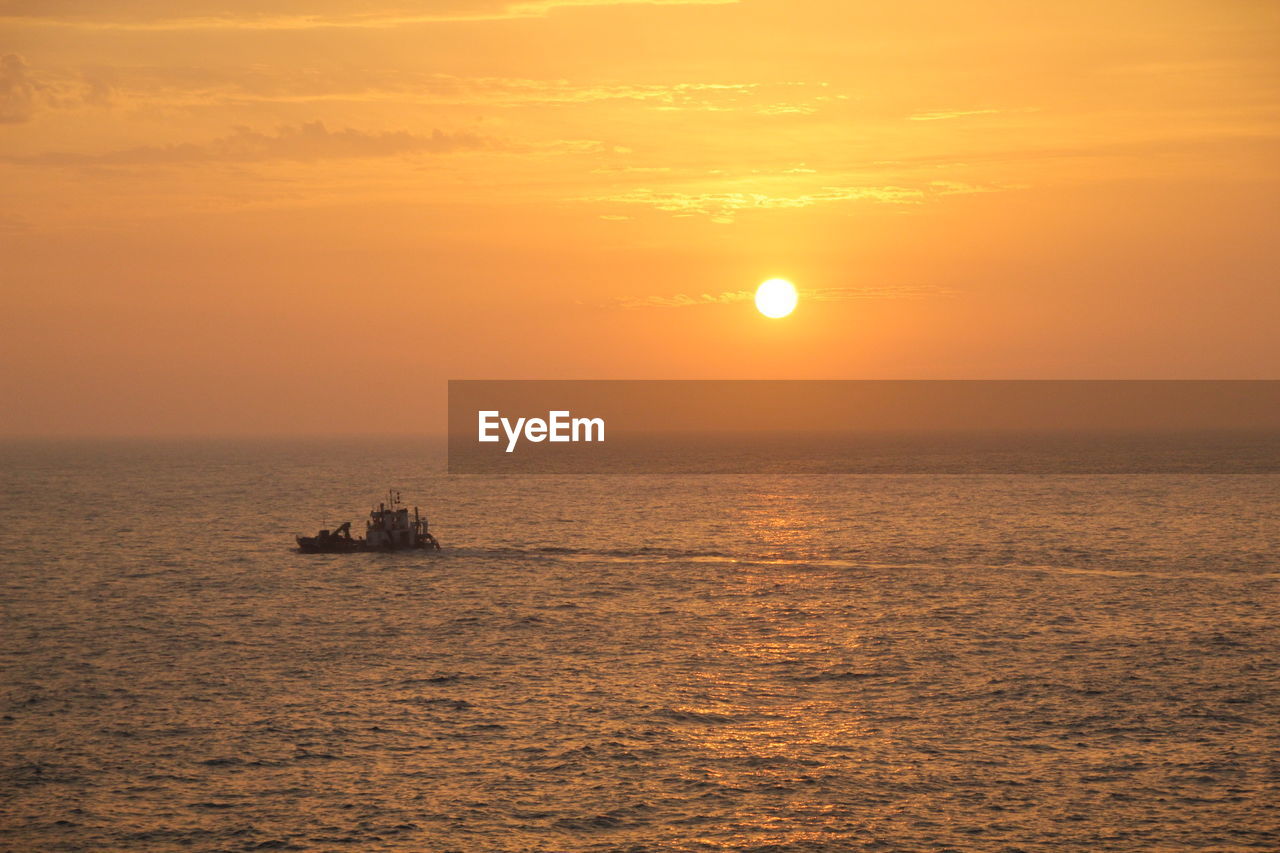 Scenic view of sunset over calm sea