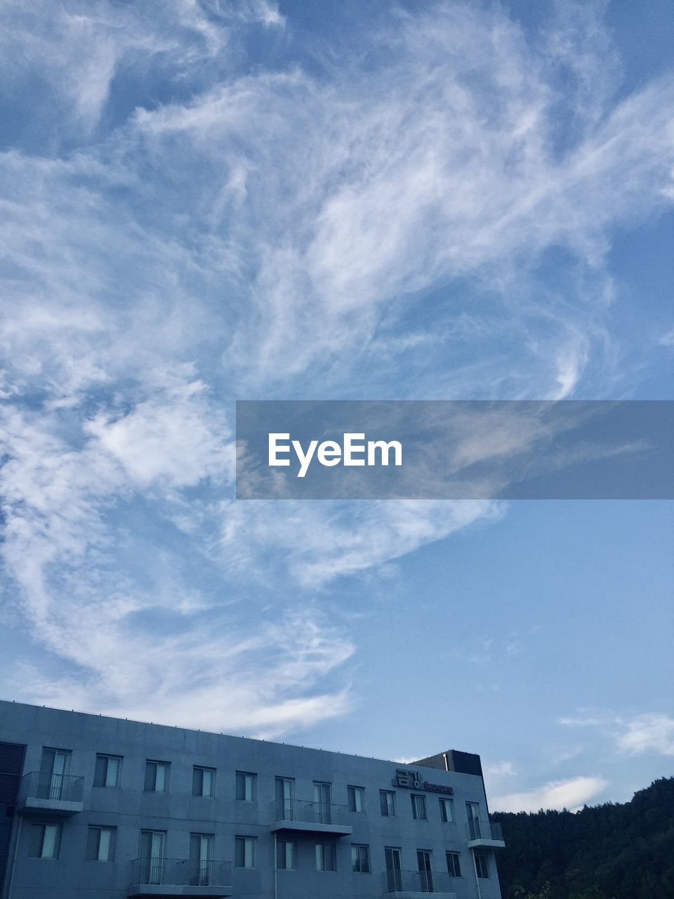 Low angle view of buildings against cloudy sky