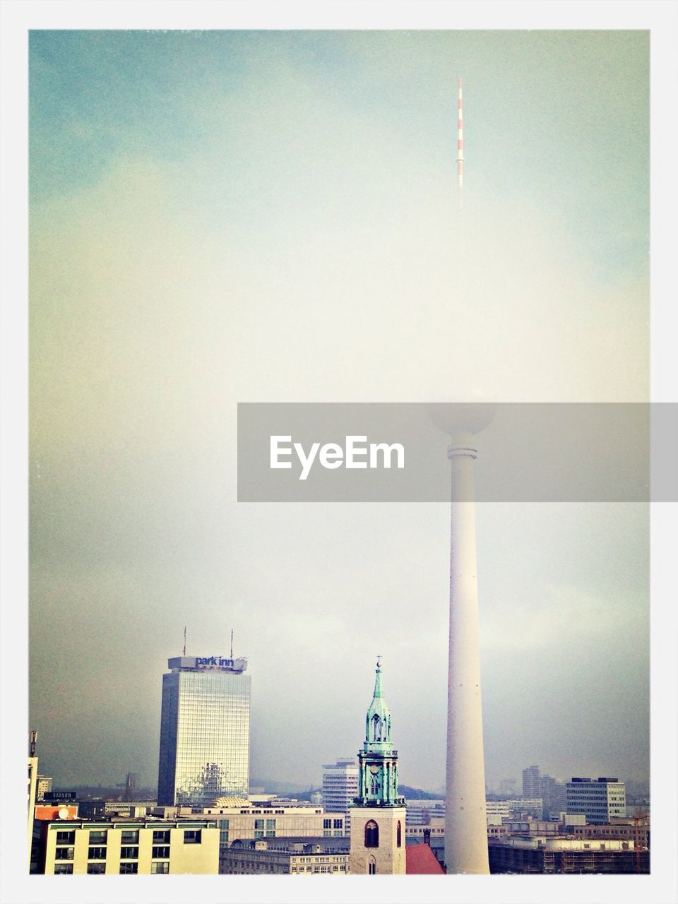 Fernsehturm and st marys church in foggy weather