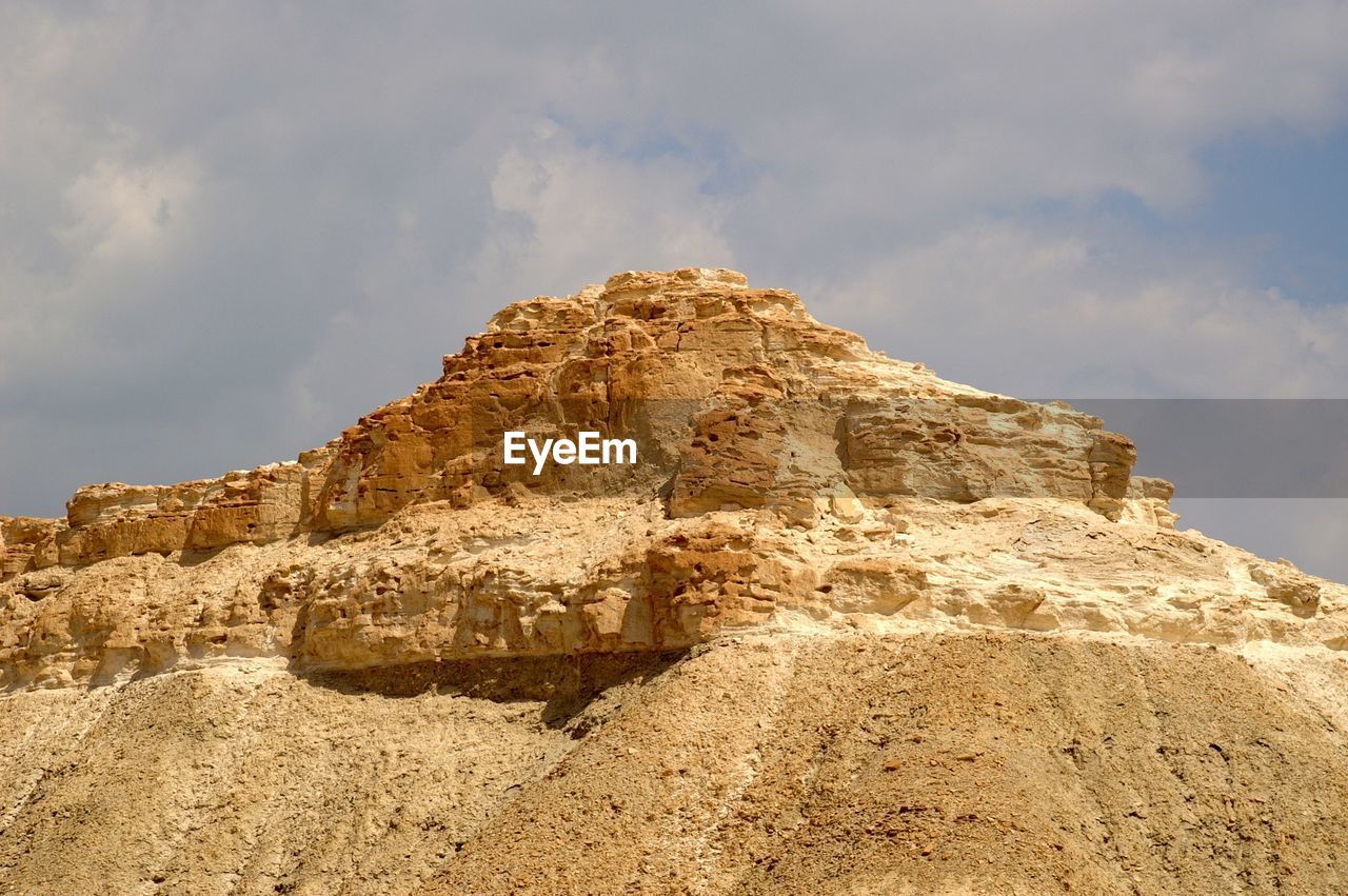 LOW ANGLE VIEW OF ROCK FORMATION ON LAND AGAINST SKY