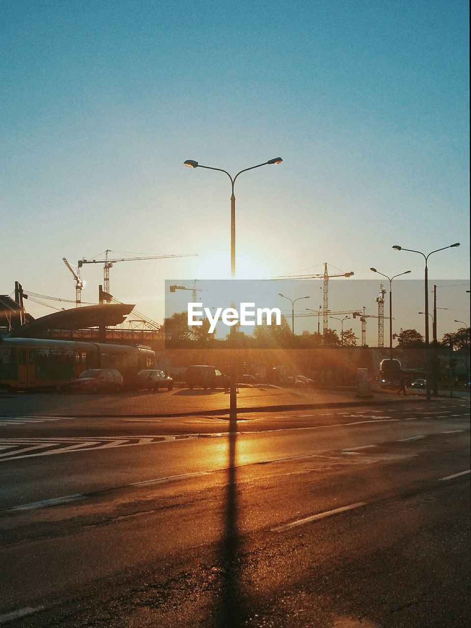 Low angle view of street lights against clear sky during sunrise