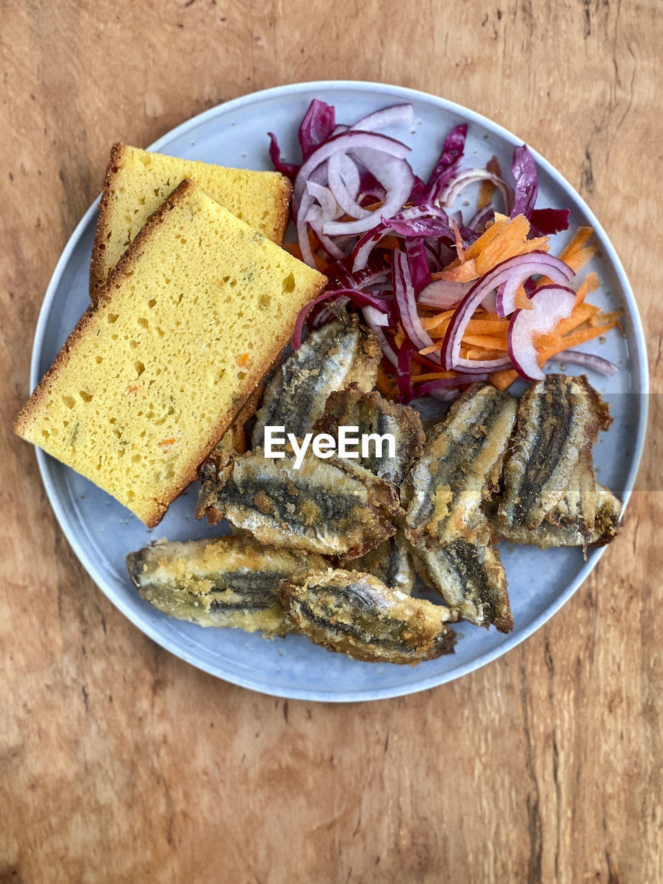 Fried anchovy fish and corn bread on table with salad traditional turkish cuisine local sea food