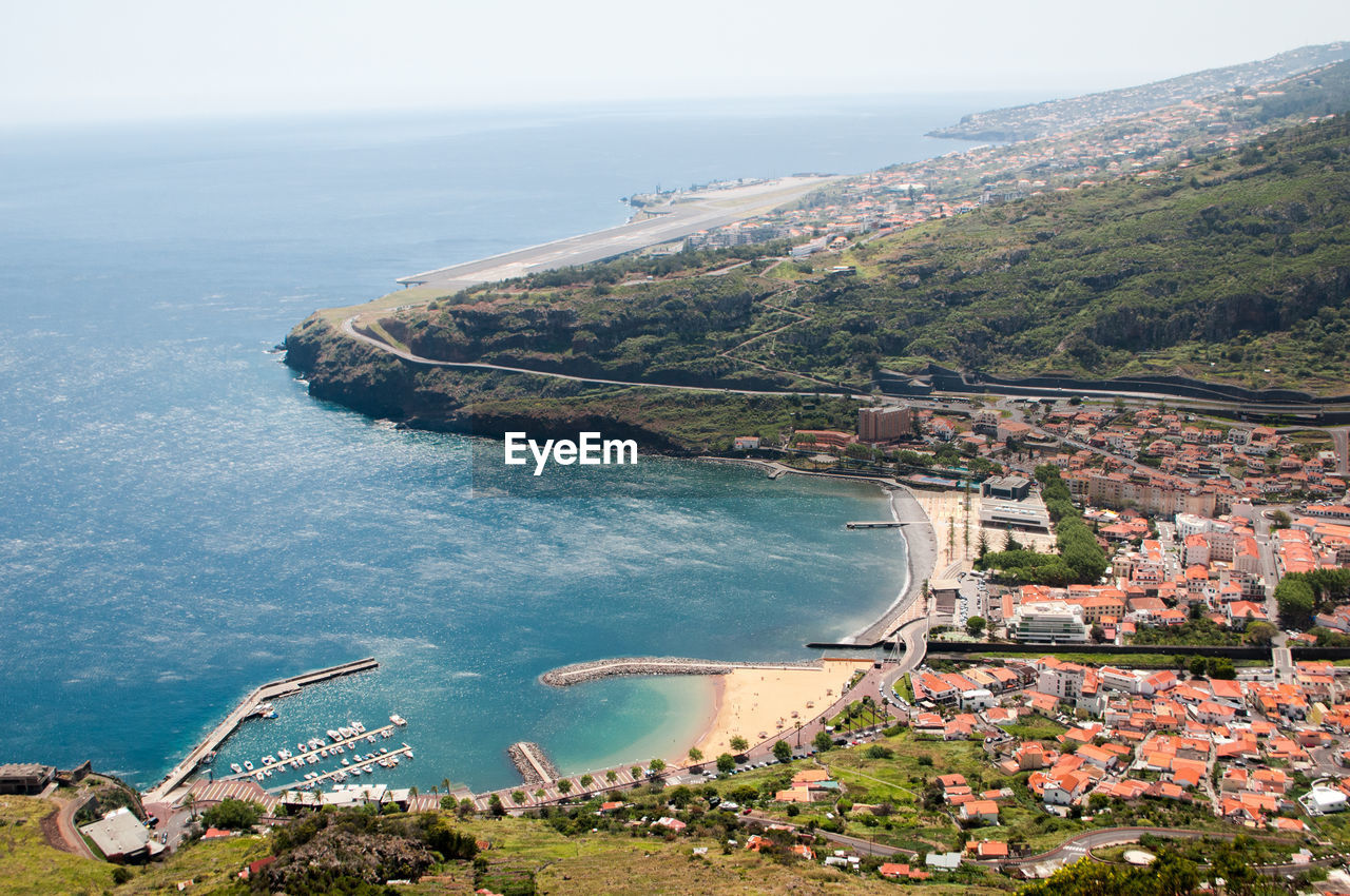 High angle view of sea and buildings against sky