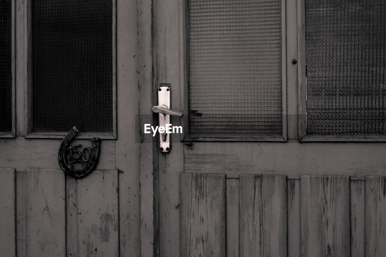 Closed wooden door of old house