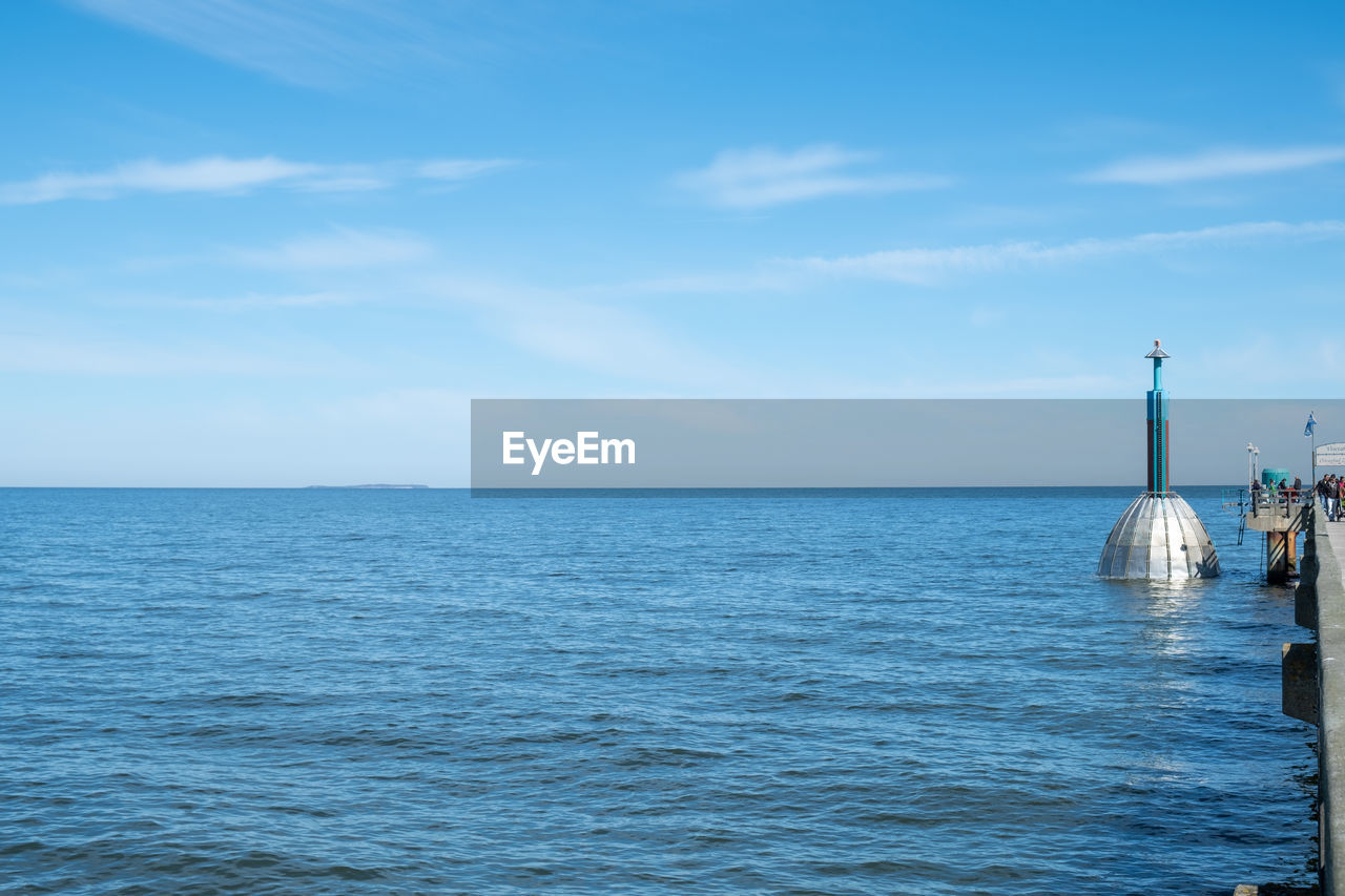 Scenic view of sea against blue sky