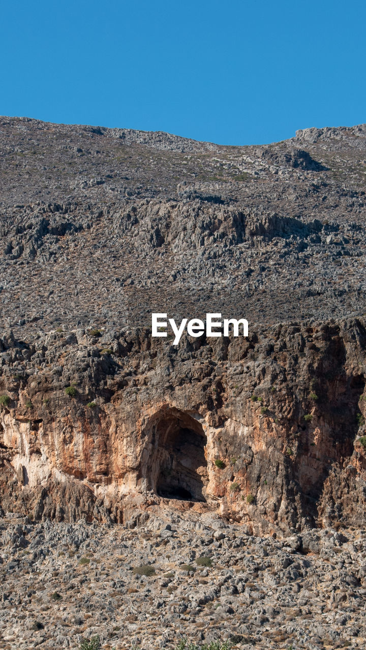 landscape, nature, sky, environment, land, clear sky, rock, scenics - nature, desert, no people, geology, natural environment, non-urban scene, ancient history, climate, day, blue, mountain, arid climate, soil, sunny, beauty in nature, travel destinations, outdoors, tranquility, dry, architecture, rock formation, travel, remote, history, sunlight, physical geography, extreme terrain, wadi, plateau, tranquil scene, ruins, ancient, wilderness, semi-arid