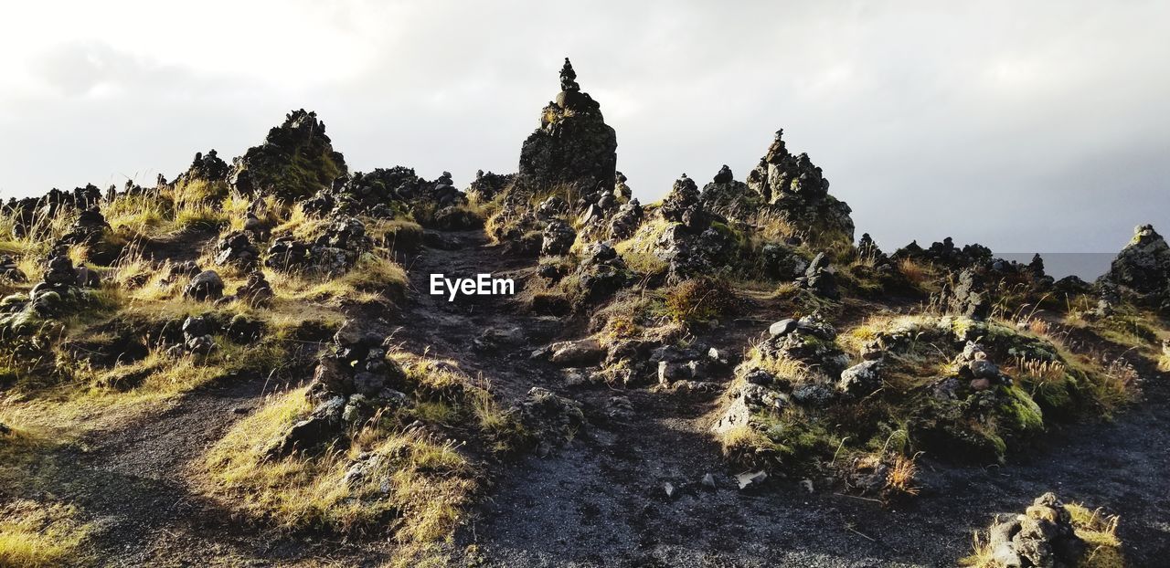 Low angle view of rock formation against sky