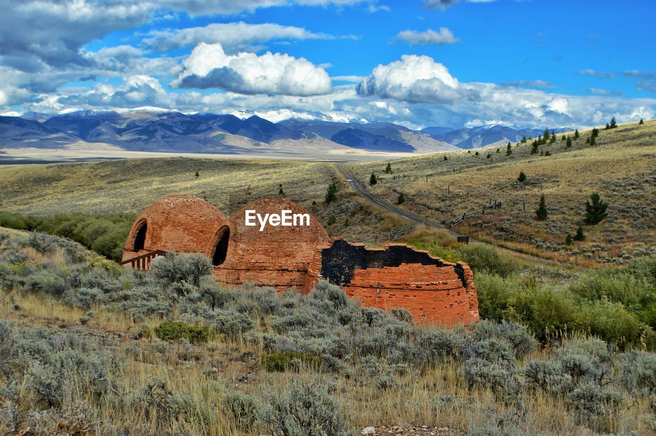 Birch creek charcoal kilns on grassy field against sky