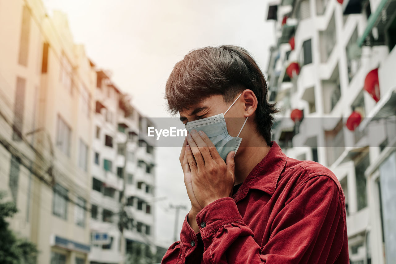 Man with medical face mask in the city. air pollution, concept of coronavirus quarantine. mers-cov.