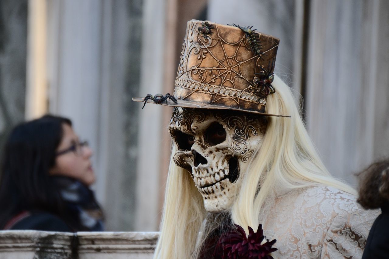 Person wearing human skull mask at carnival