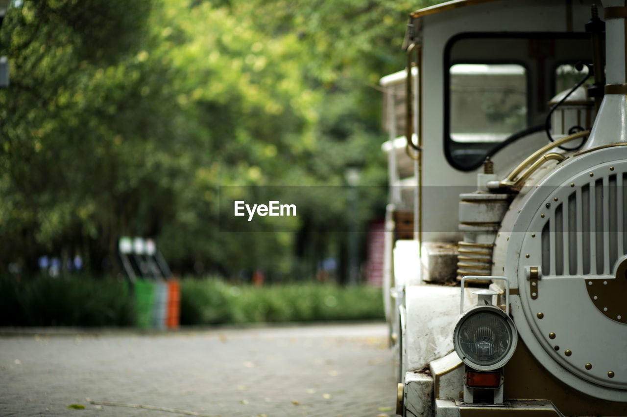 CLOSE-UP OF TRAIN ON ROAD