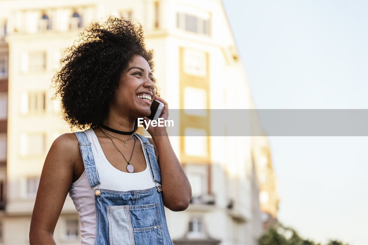 Smiling woman talking on smart phone