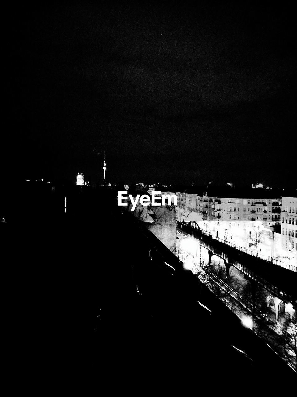 VIEW OF ILLUMINATED CITY AT NIGHT