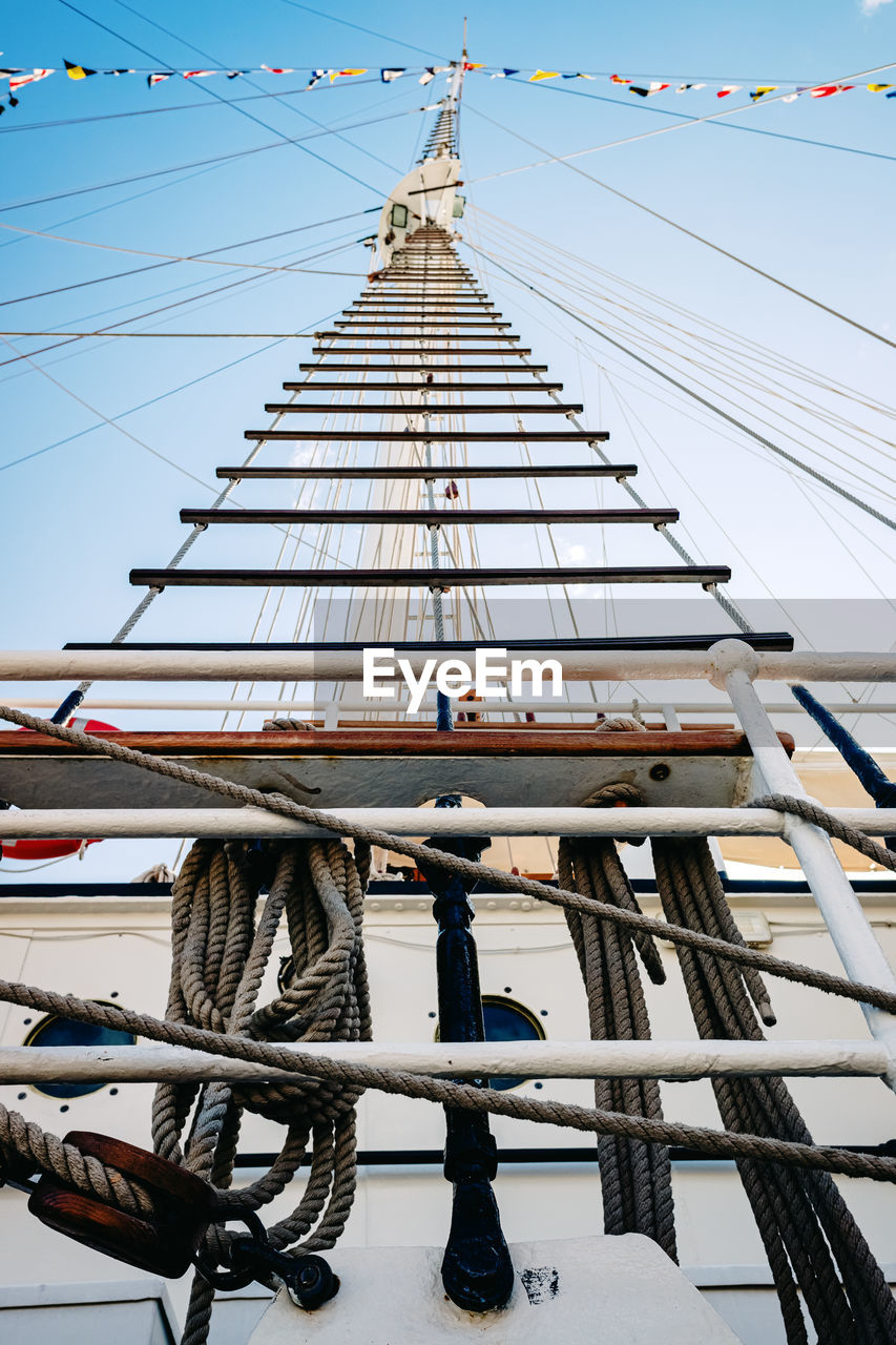 LOW ANGLE VIEW OF SAILBOAT AGAINST BUILDING