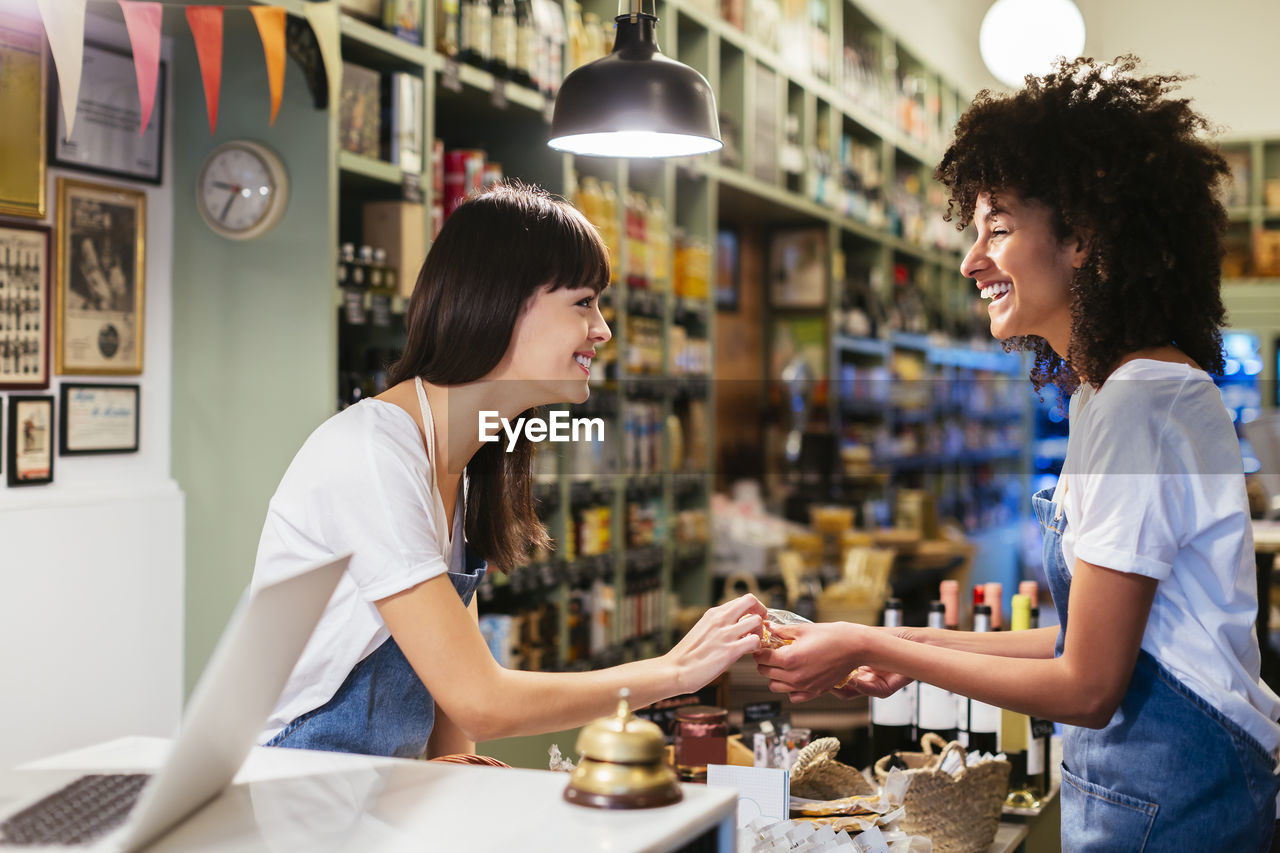 Two happy women at the counter in a store