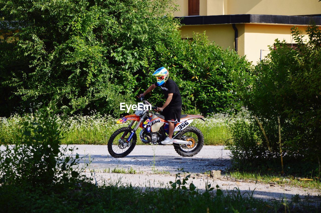 MAN RIDING BICYCLE ON STREET