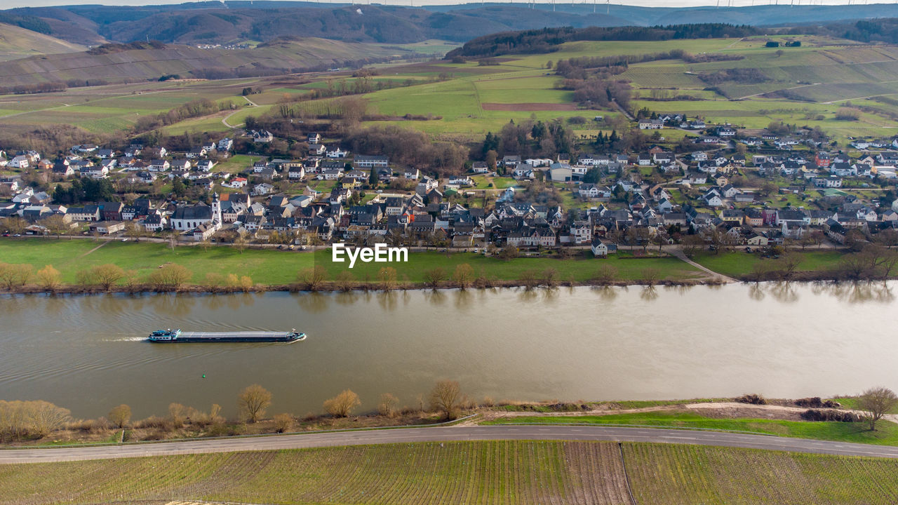 Aerial view of the river moselle valley with cargo ship and the village brauneberg