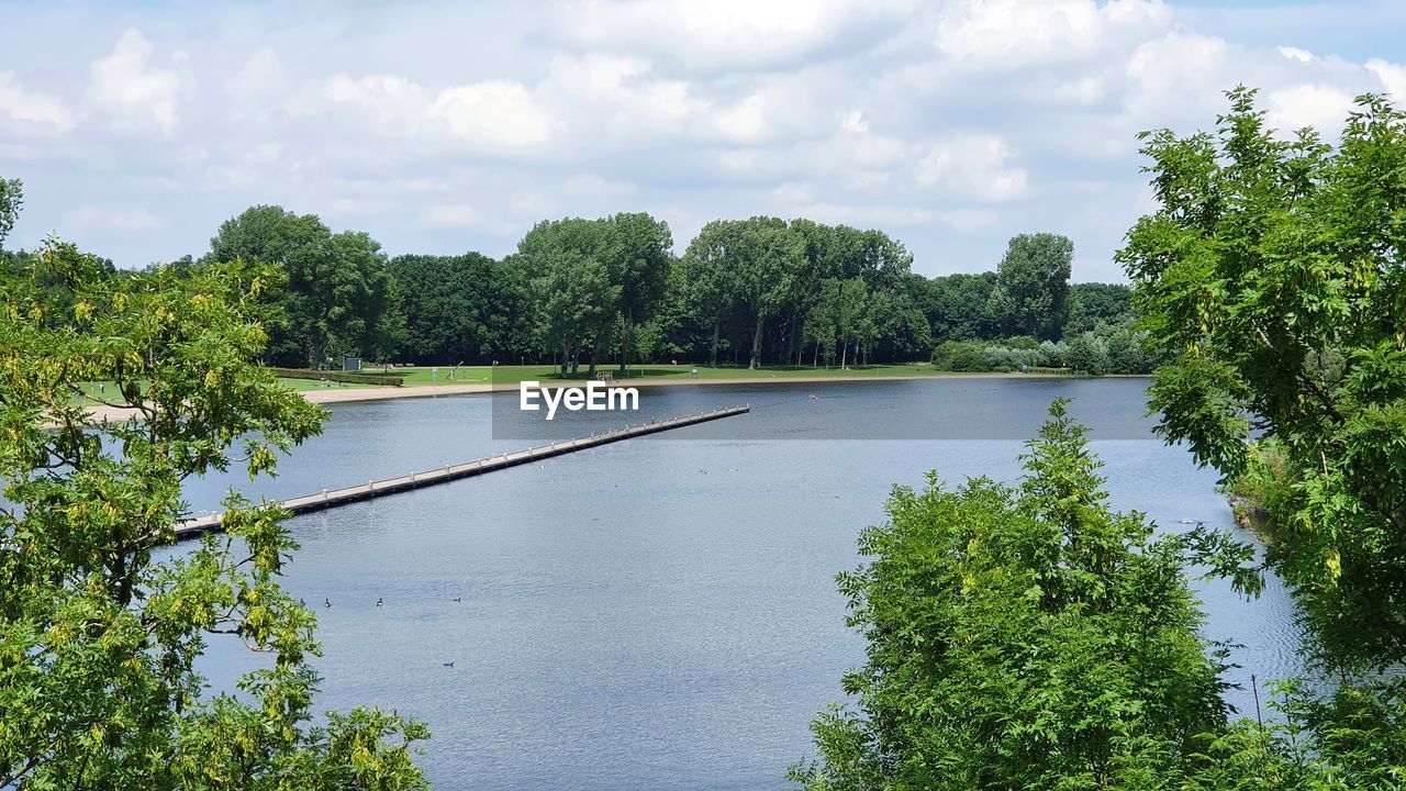 SCENIC VIEW OF LAKE AND TREES AGAINST SKY