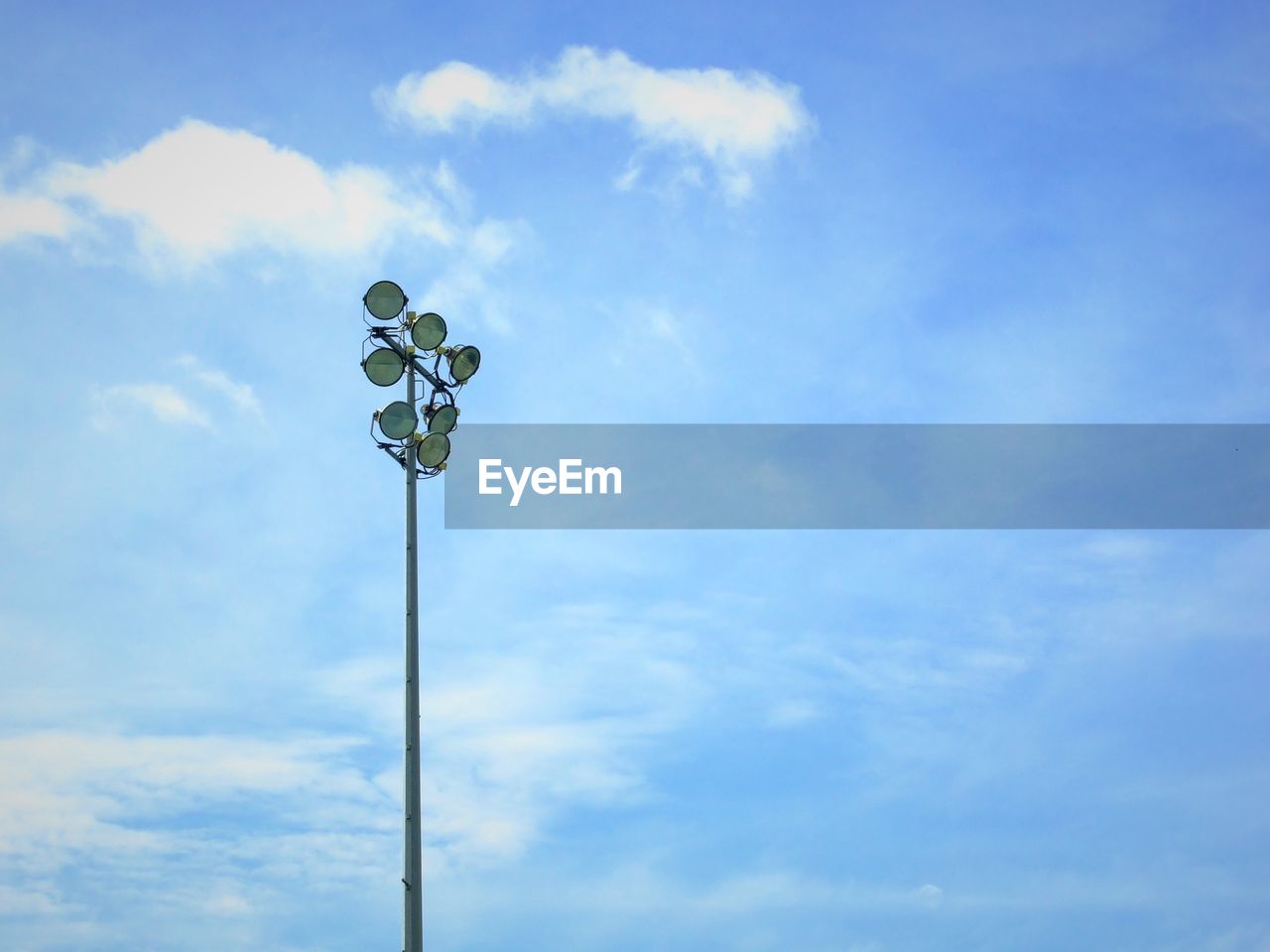 LOW ANGLE VIEW OF STREET LIGHTS AGAINST BLUE SKY