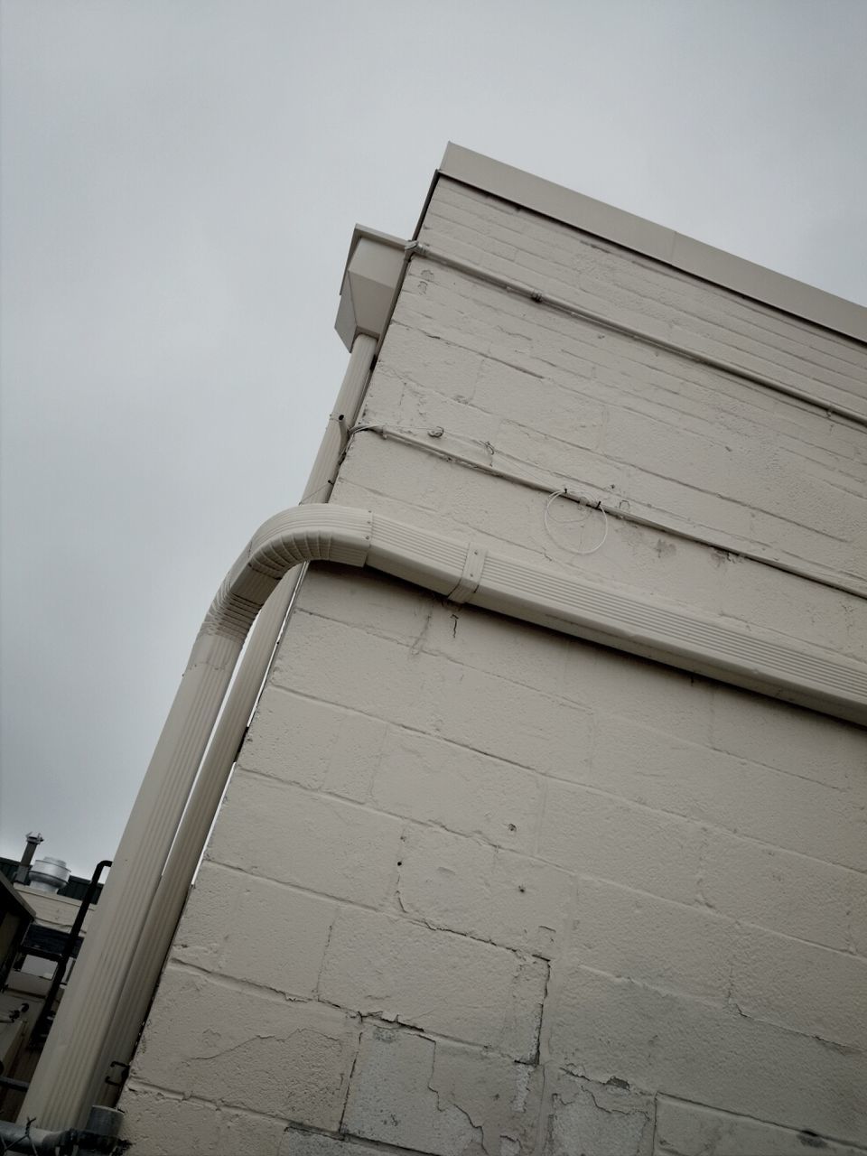 Low angle view of white exterior wall of building