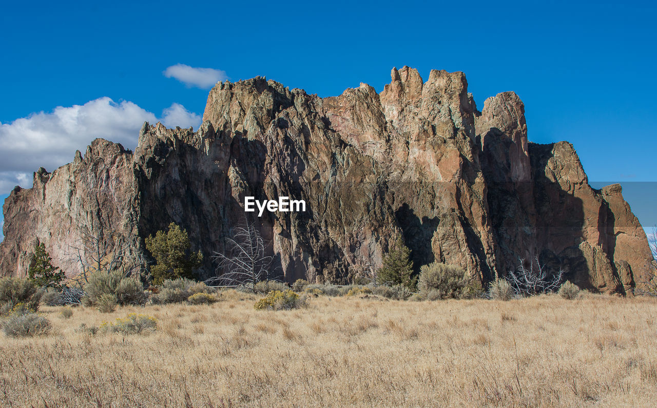 Rock formations on landscape against sky