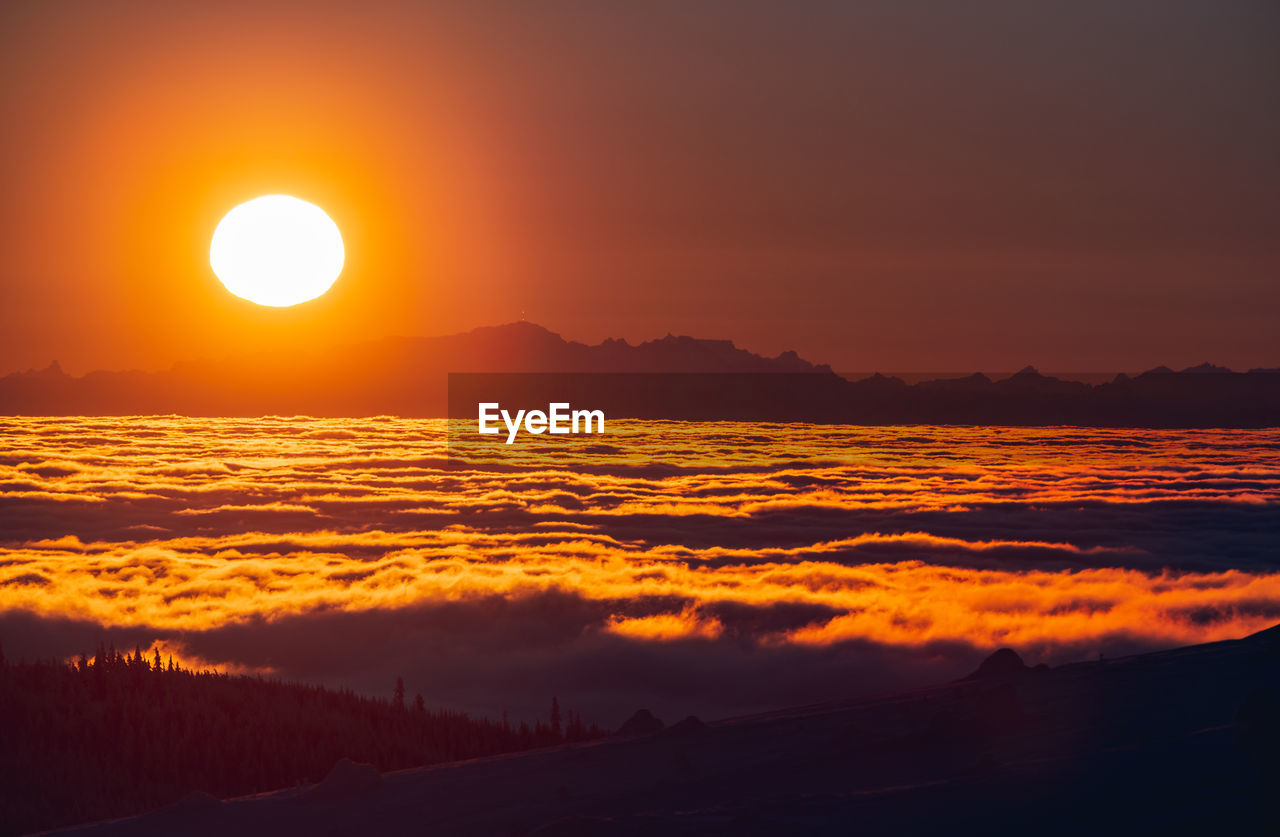 Scenic view of sea against romantic sky at sunset