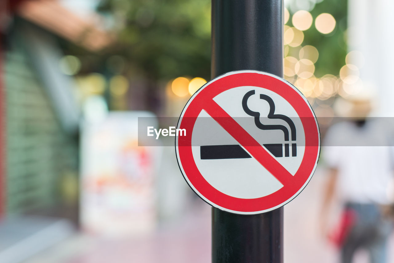 Close-up of no smoking sign on pole