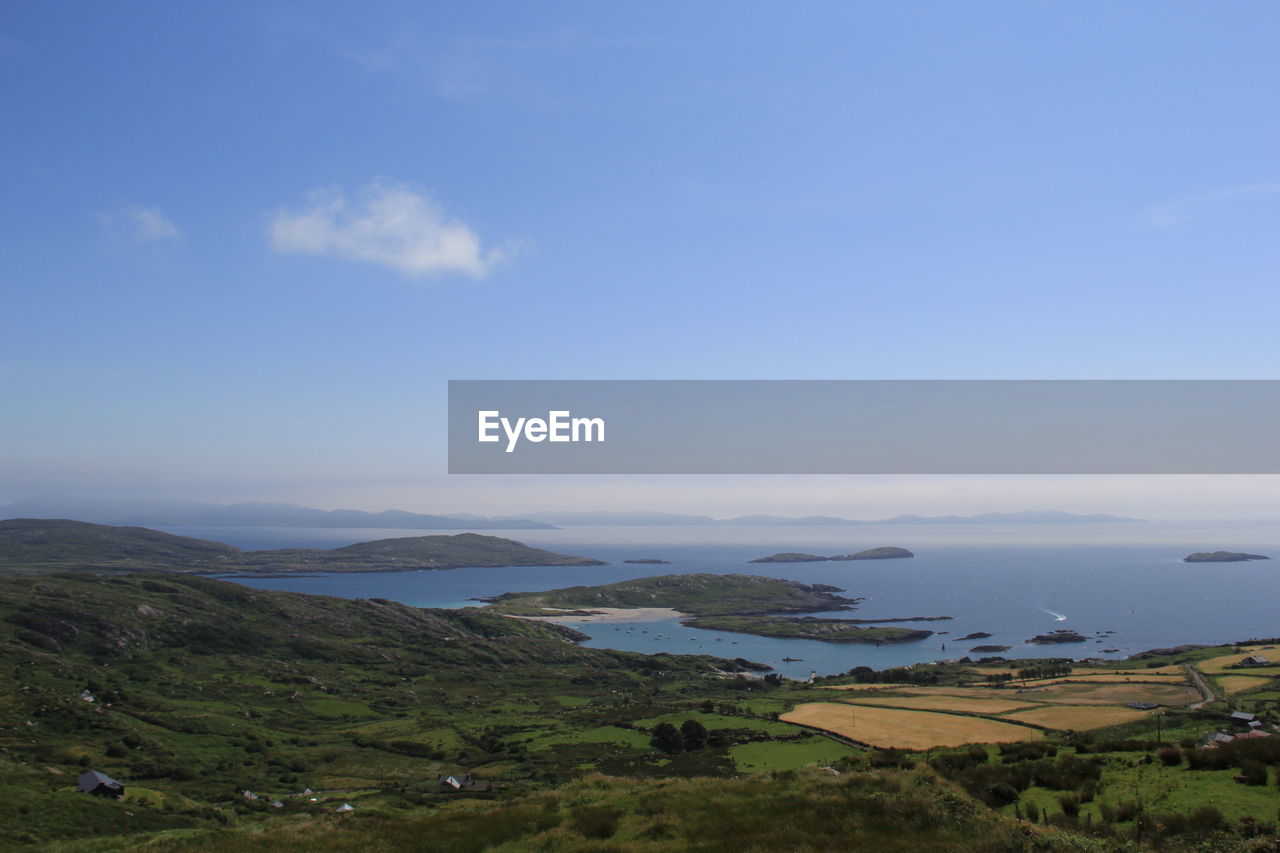 Scenic view of mountains against blue sky