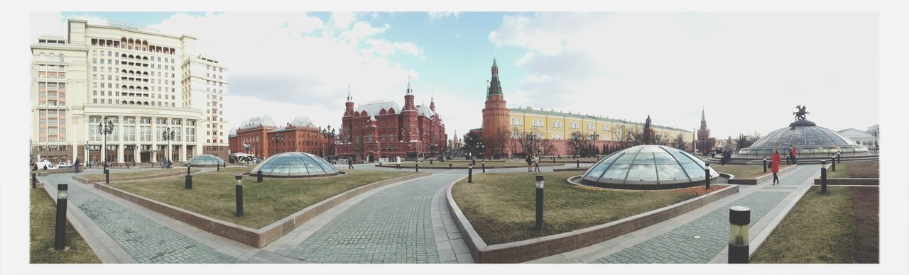 Panoramic shot of buildings with walkways in foreground