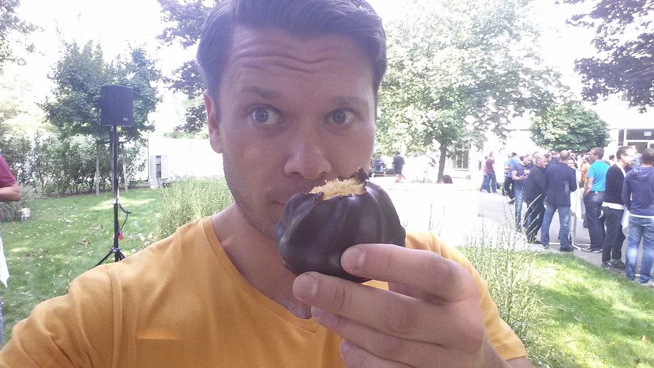 Close-up of young man eating dessert