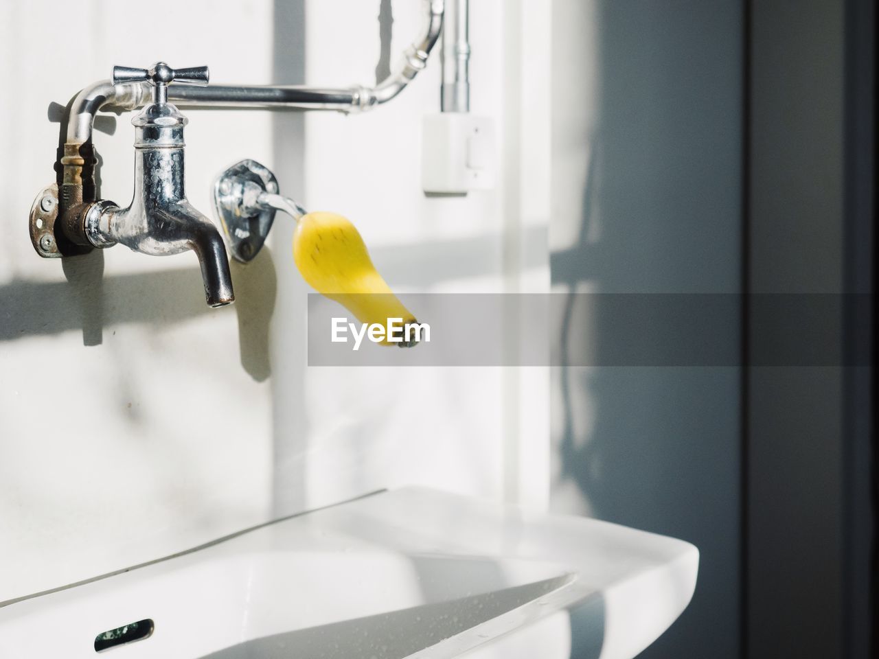 Close-up of faucet in bathroom at home
