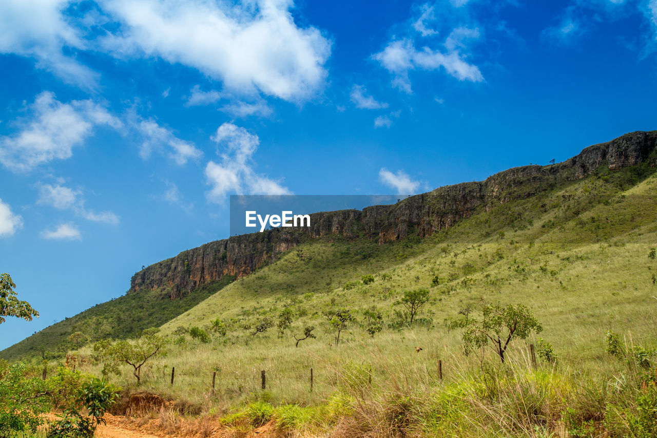 Scenic view of mountains against blue sky