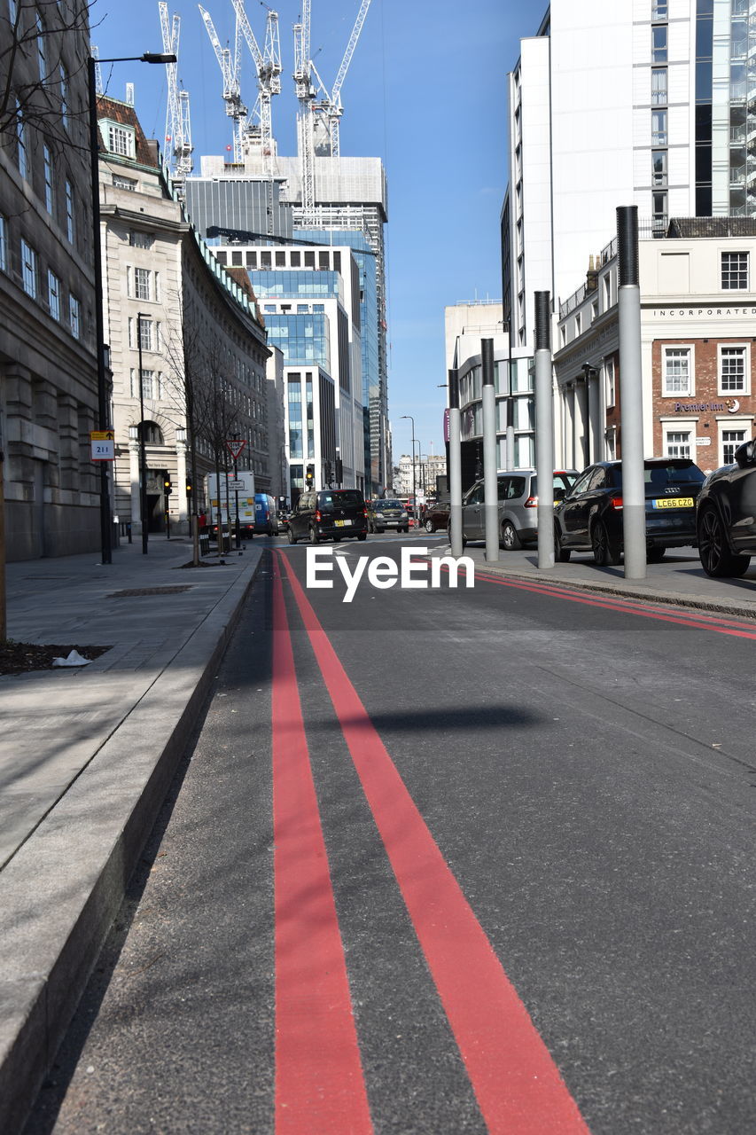 SURFACE LEVEL OF ROAD BY BUILDINGS AGAINST SKY