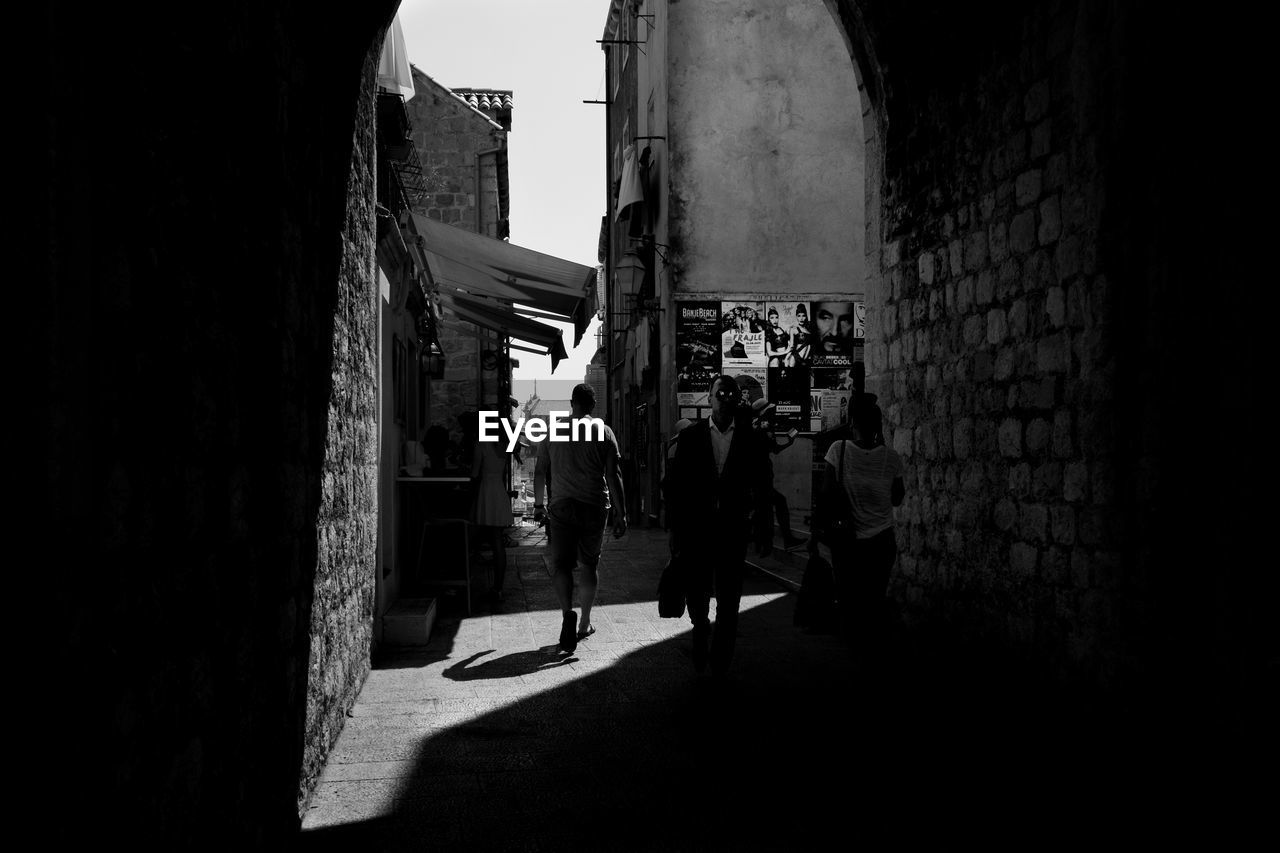 PEOPLE WALKING ON STREET IN CITY