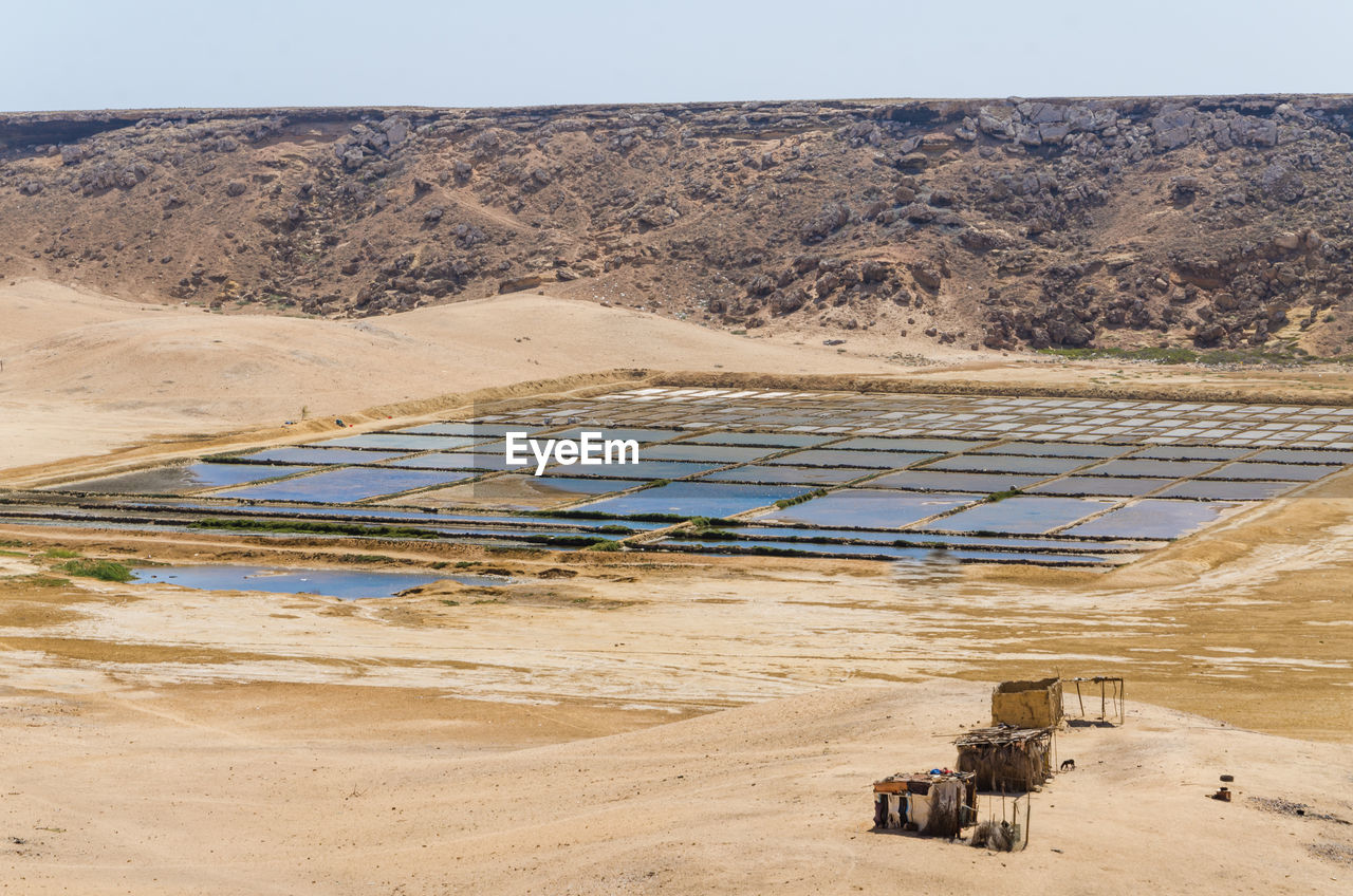 Scenic view salt mining against sky in mucuio, namib desert, angola