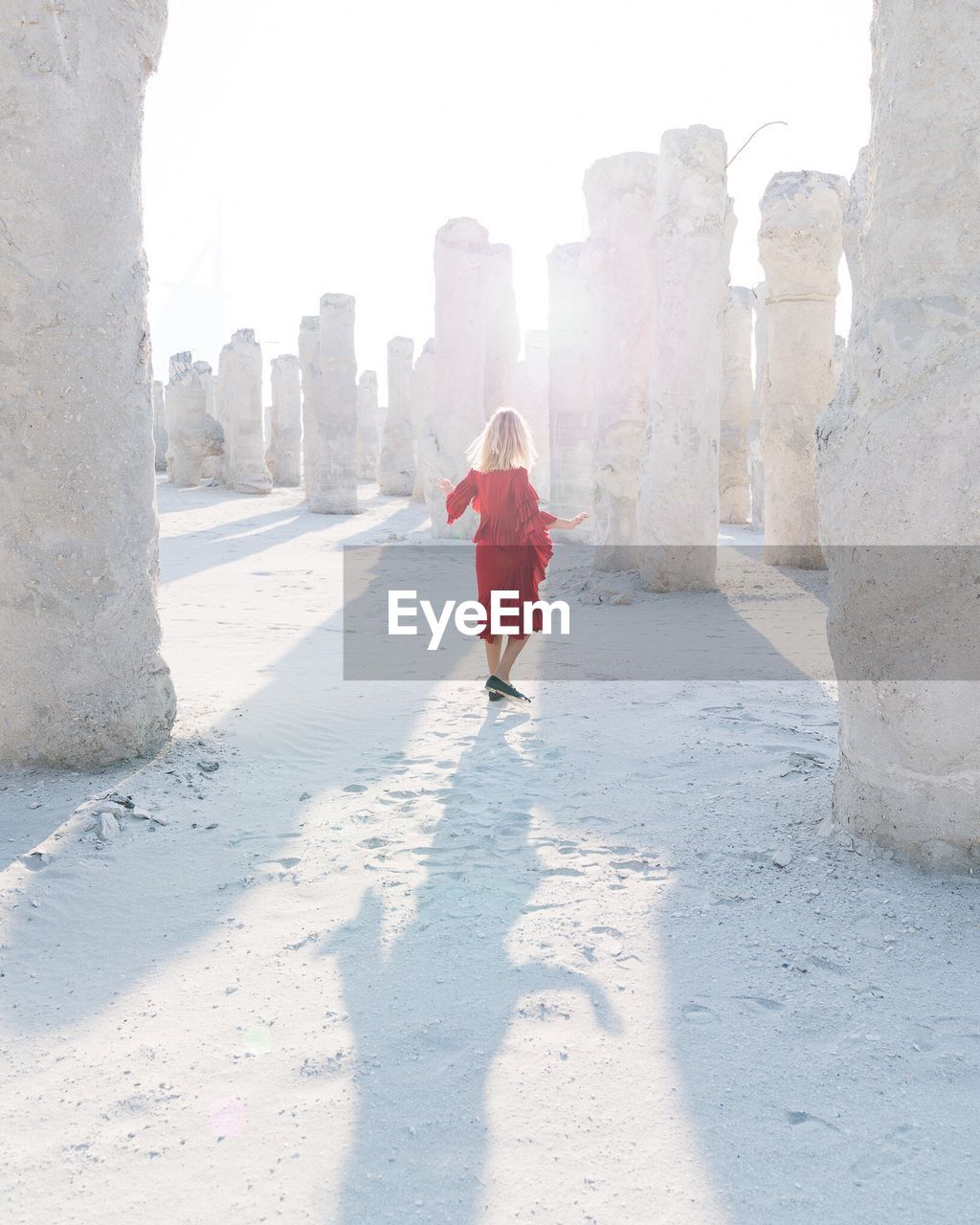 Full length of woman standing amidst old ruins