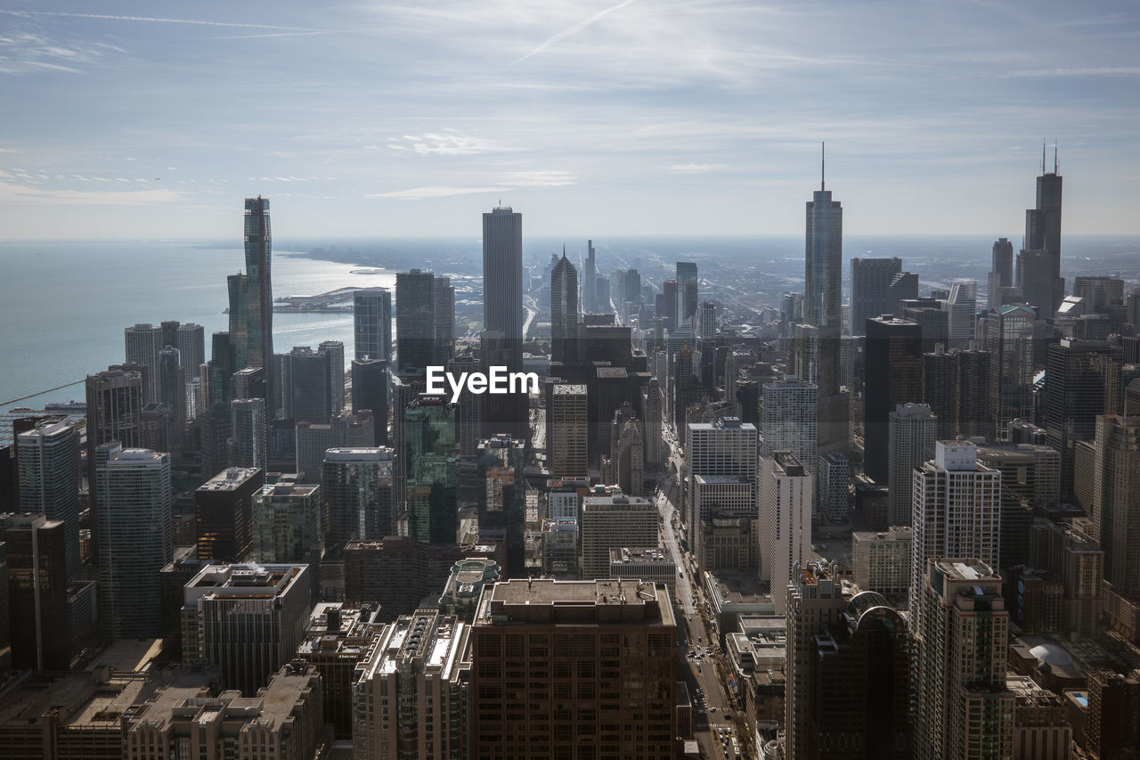 AERIAL VIEW OF MODERN CITY BUILDINGS AGAINST SKY