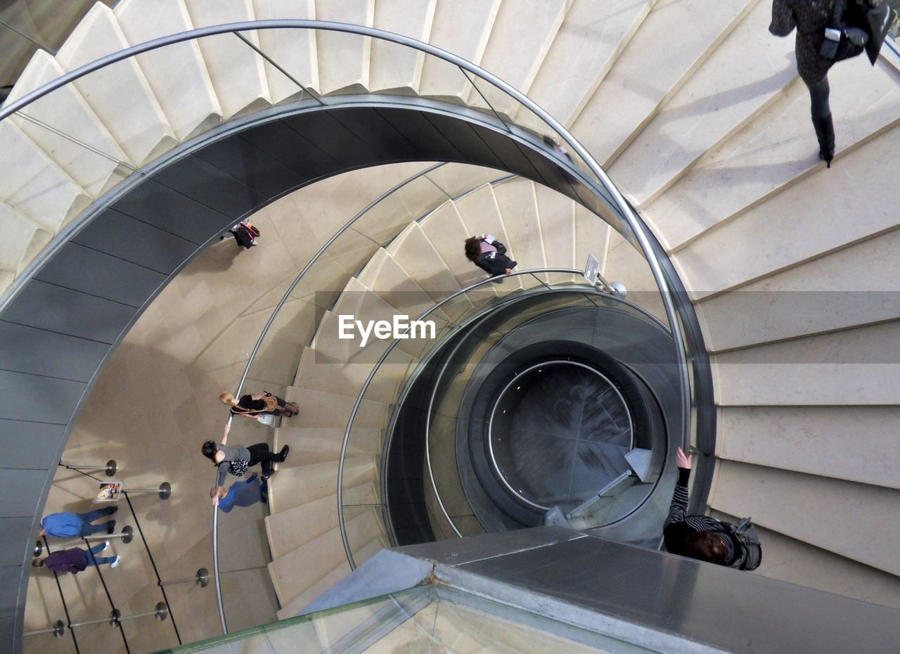 HIGH ANGLE VIEW OF PEOPLE ON ESCALATOR