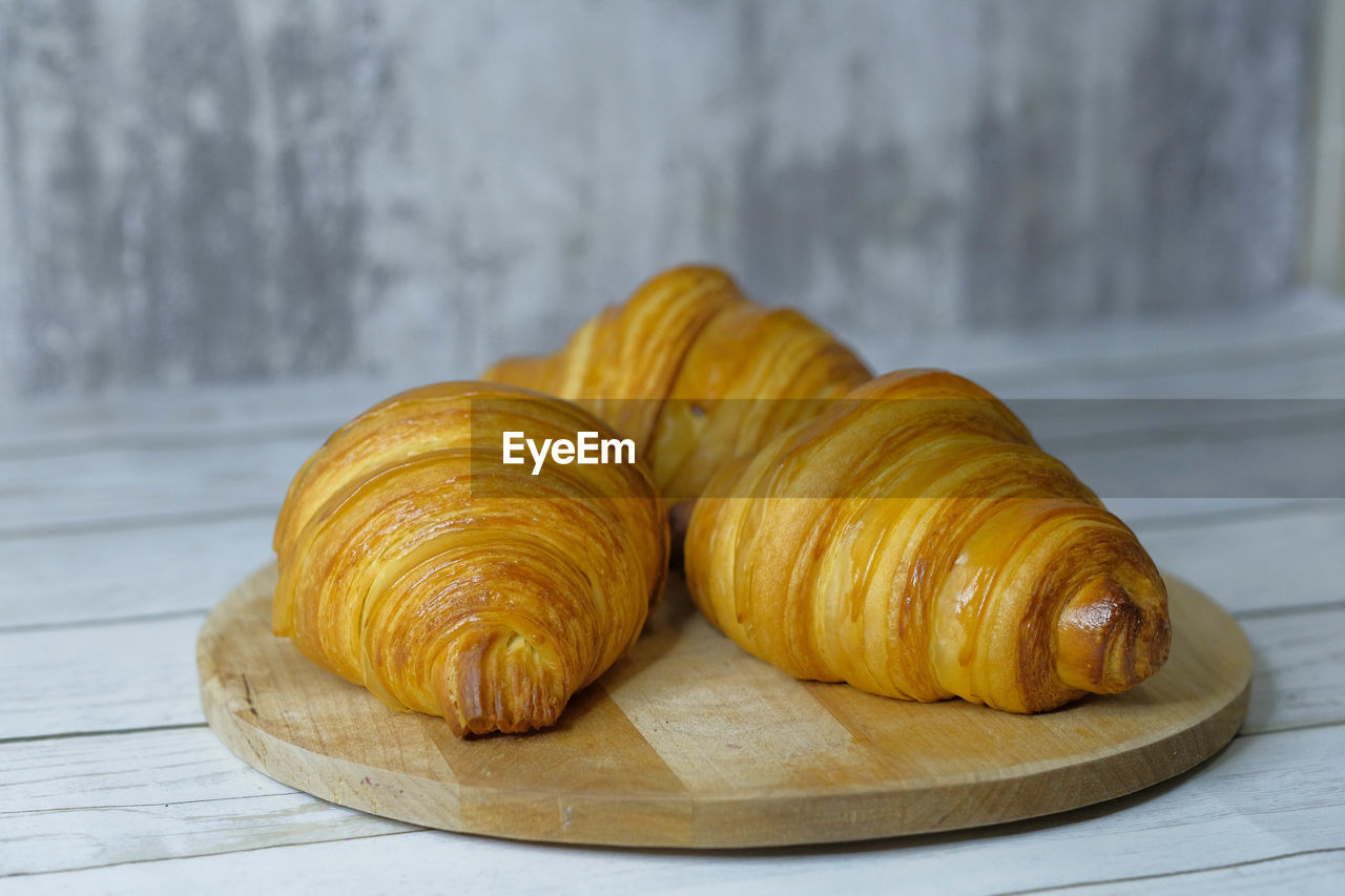 food and drink, food, freshness, croissant, dessert, baked, wood, produce, no people, dish, french food, fast food, still life, indoors, healthy eating, sweet food, viennoiserie, pastry, table, cuisine, close-up, wellbeing, focus on foreground