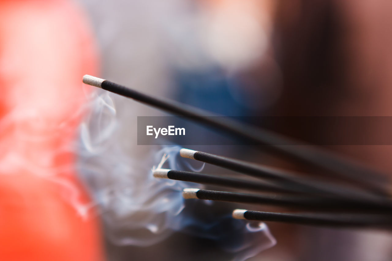 Close-up of incense stick in temple