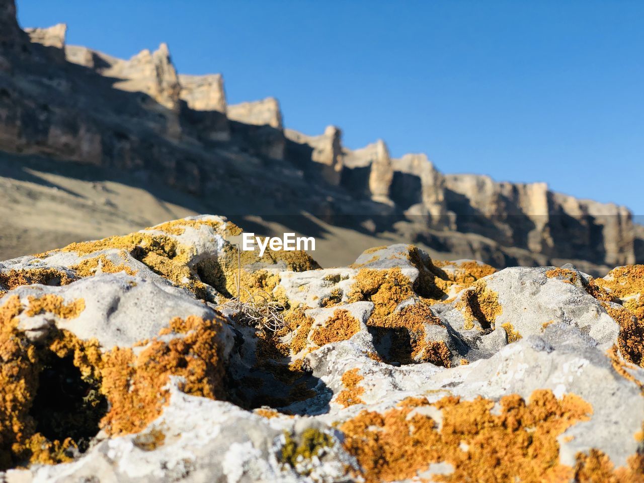 Low angle view of rocks against clear sky