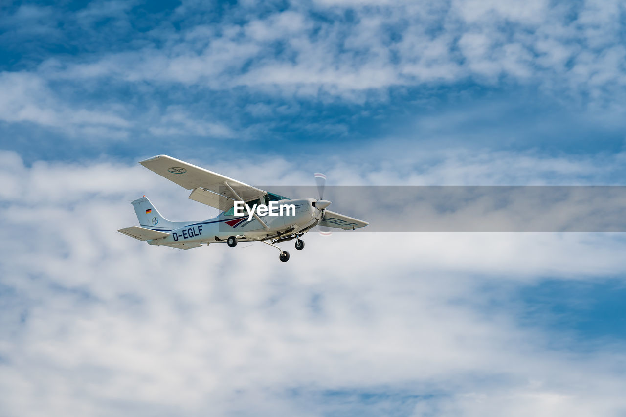 LOW ANGLE VIEW OF AIRPLANE IN SKY