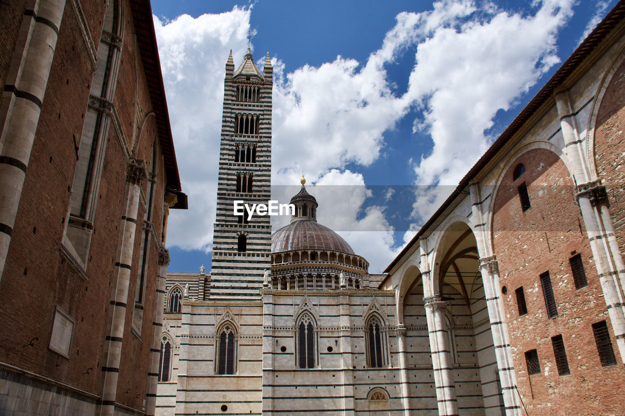 Low angle view of siena cathedral against sky