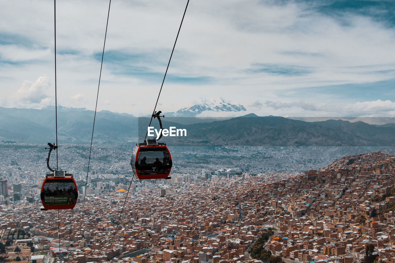 HIGH ANGLE VIEW OF OVERHEAD CABLE CAR ON MOUNTAIN